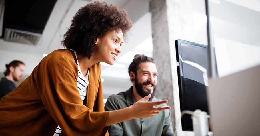 Woman and man looking at computer enjoying the power of capex software.